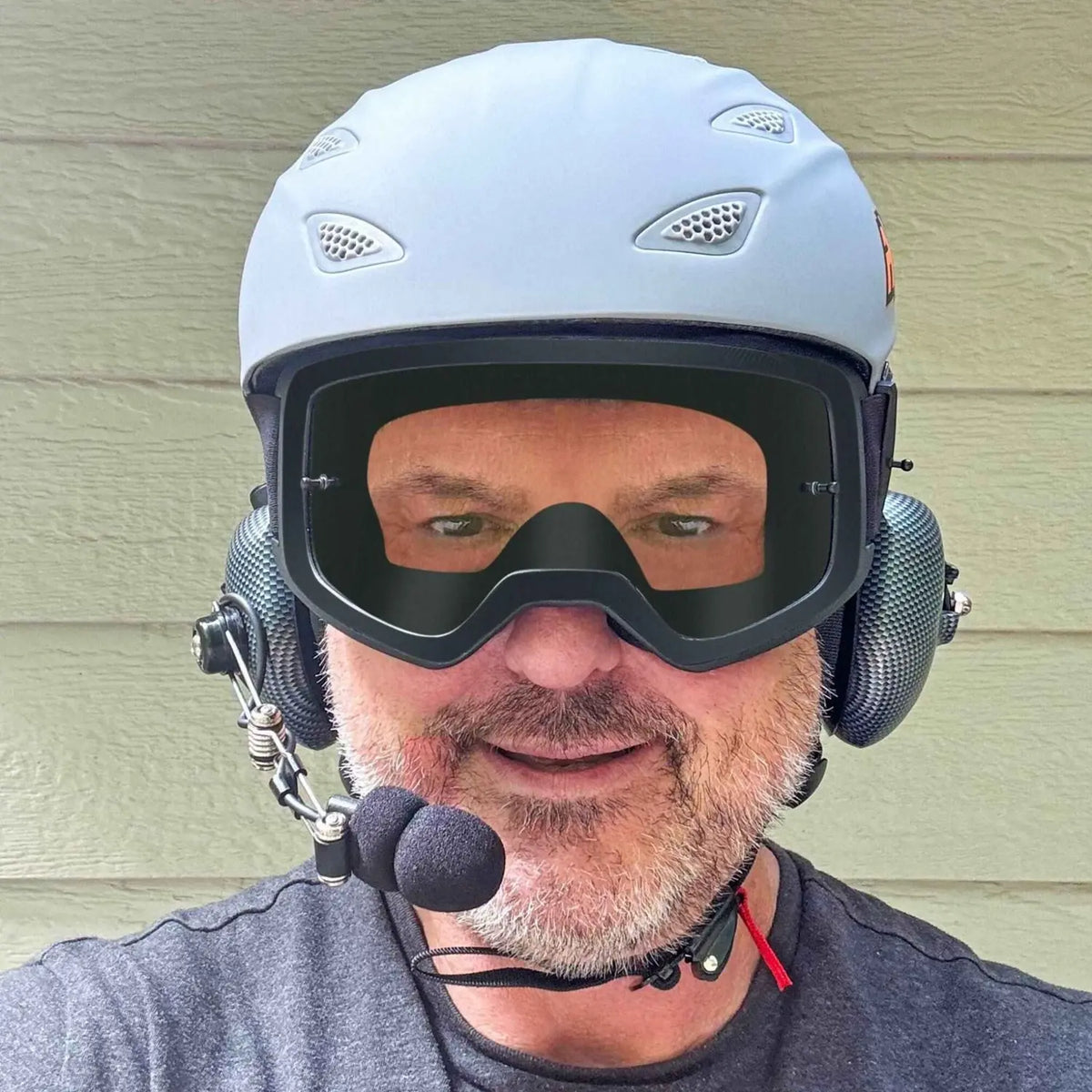 Person wearing AXEL GRIT DOT certified Helmet with goggles and rugged radios headset intercom