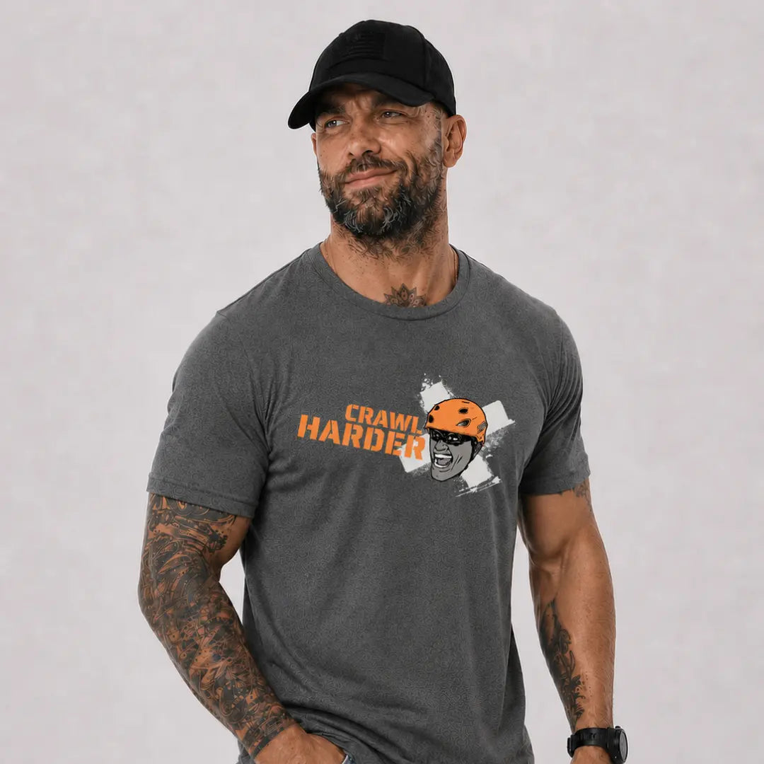 man in hat wearing gray axel off road shirt that reads crawl harder