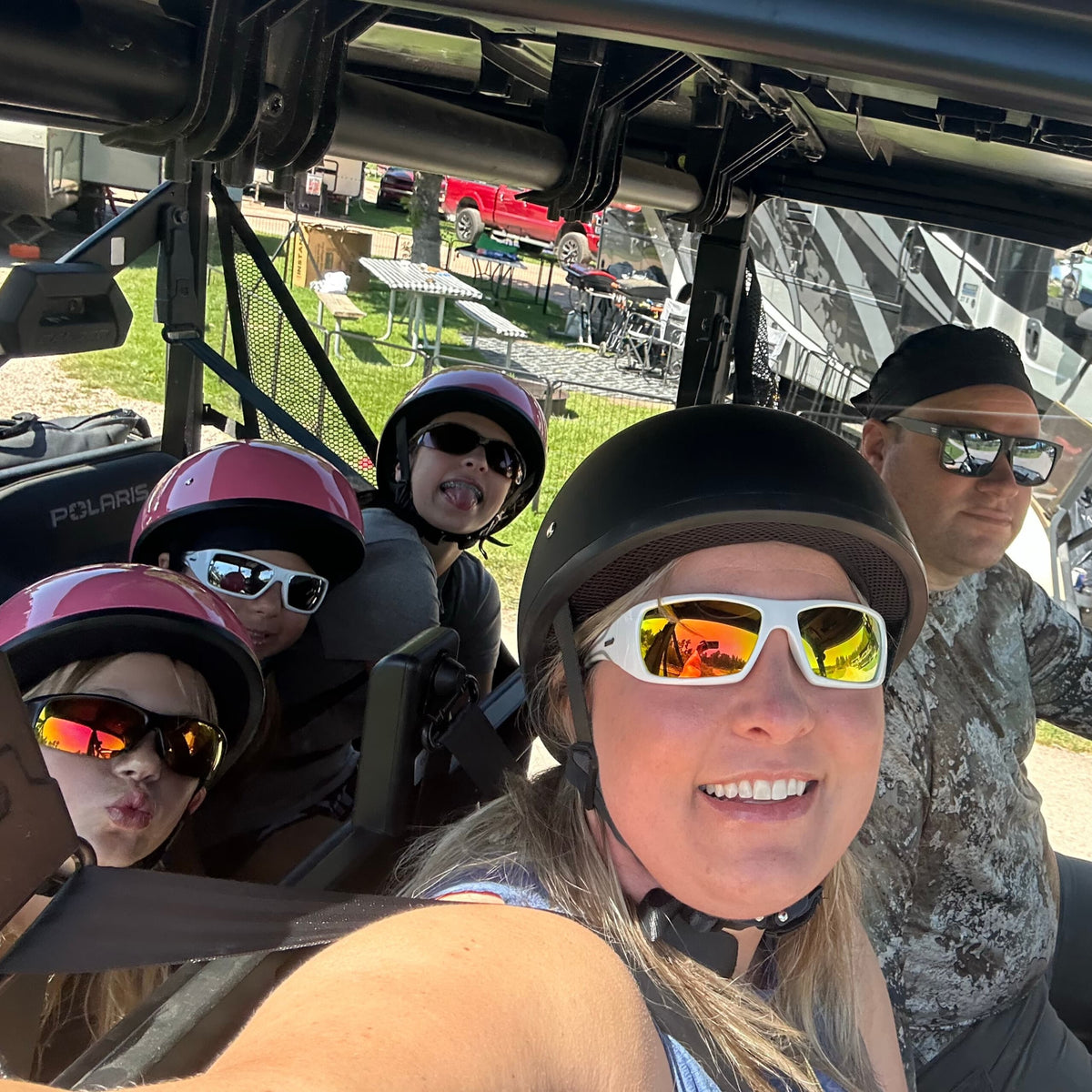 kids and adult wearing dot helmet in utv sxs buggy